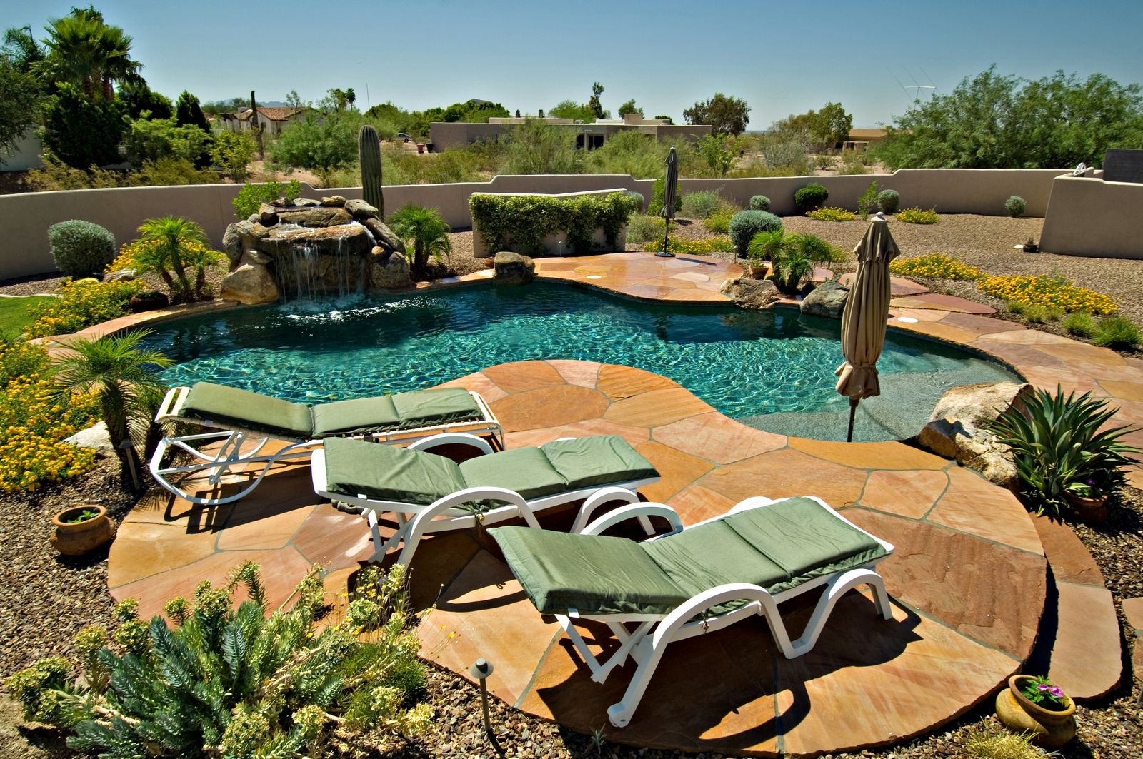 Arizona desert backyard pool with flagstone decking, saguaros, and mountain views in Queen Creek
